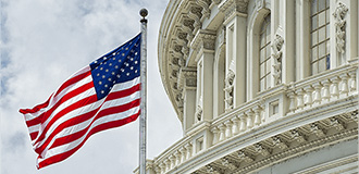 exterior view of a federal government building with a US flag