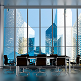 Conference table in a office building with a city outside of the windows