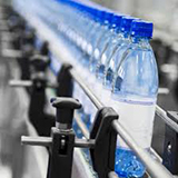 Bottled water on conveyor belt in bottling plant