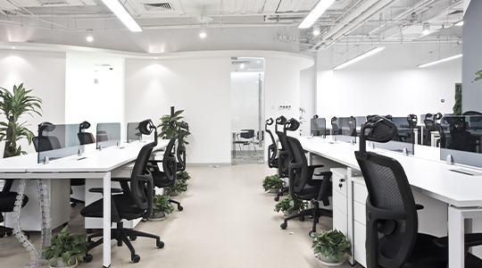 modern office space with white desks and black chairs