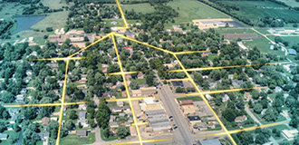 an aerial view of a rural community, with lines overlaid showing the fiber optic network for broadband