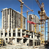 Buildings under construction with cranes and heavy equipment