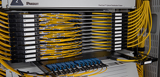 Close up of fiber optic distribution frame cassettes with fiber optic cables and connectors