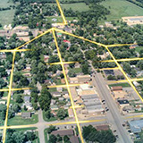 Aerial view of a small rural community with lines overlaid to show fiber optic cables